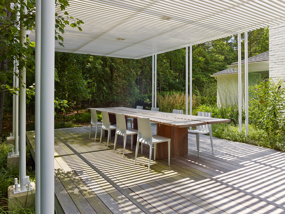 Photo of an expansive contemporary backyard patio in DC Metro with a fire feature, decking and a pergola.