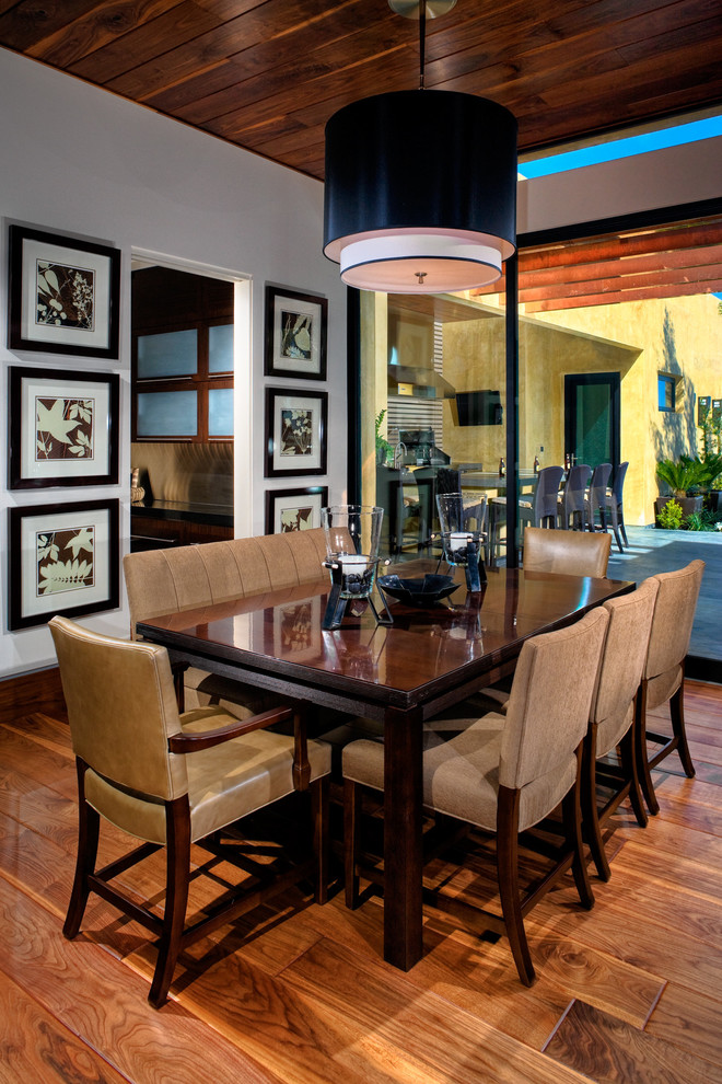 This is an example of a contemporary dining room in Las Vegas with white walls.