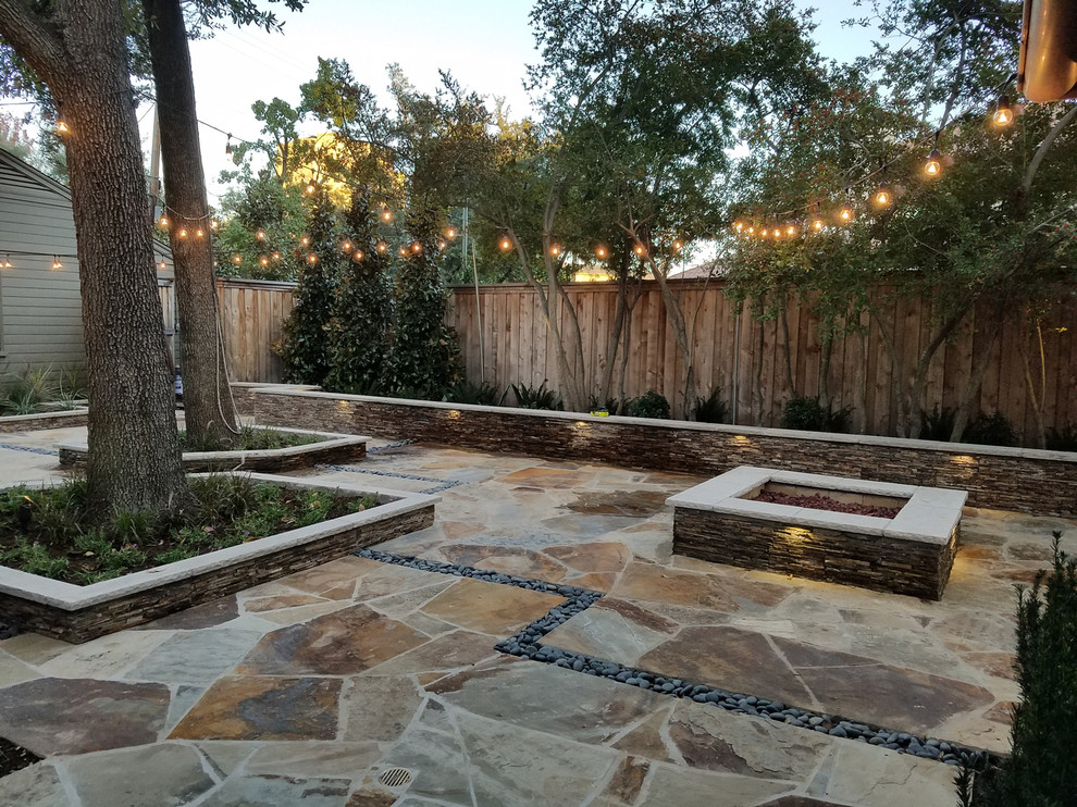 Mid-sized traditional backyard partial sun formal garden in Dallas with a container garden and natural stone pavers for summer.