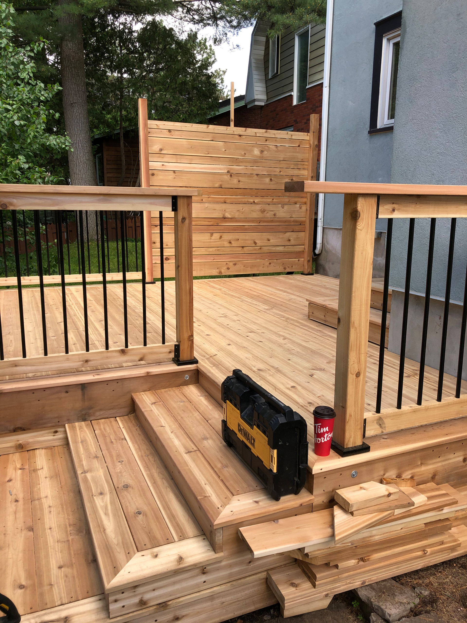 Red cedar deck with black round balusters