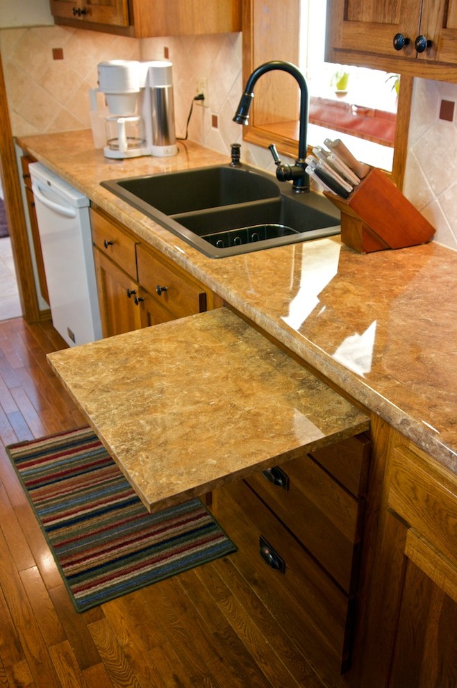 Example of a mid-sized u-shaped eat-in kitchen design with raised-panel cabinets, medium tone wood cabinets, laminate countertops, beige backsplash, stone tile backsplash, white appliances and an island