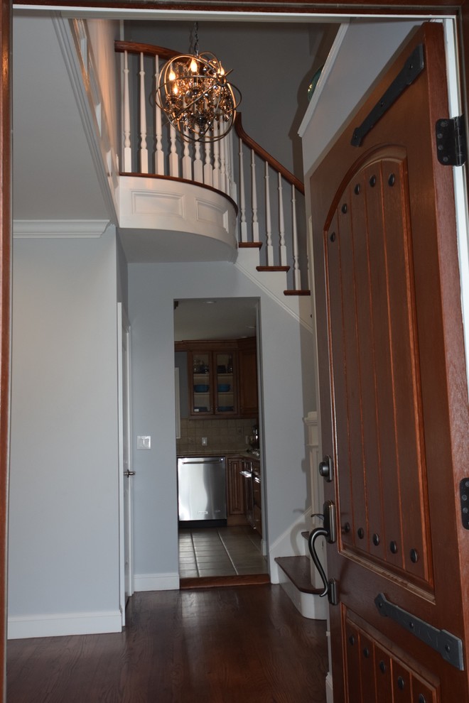 Example of a transitional dark wood floor entryway design