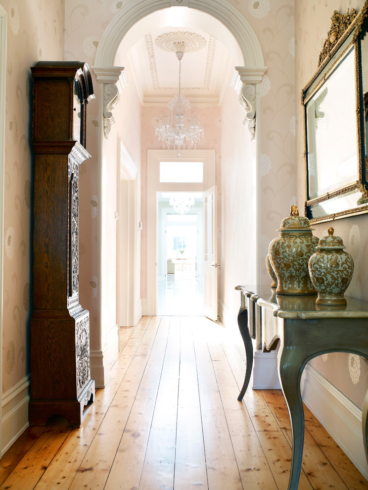 This is an example of a mid-sized traditional entry hall in Melbourne with beige walls, light hardwood floors, a double front door and a black front door.