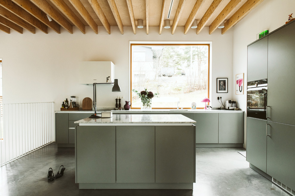 Scandinavian l-shaped kitchen in Stockholm with an undermount sink, flat-panel cabinets, grey cabinets, panelled appliances, concrete floors, with island, grey floor and white benchtop.
