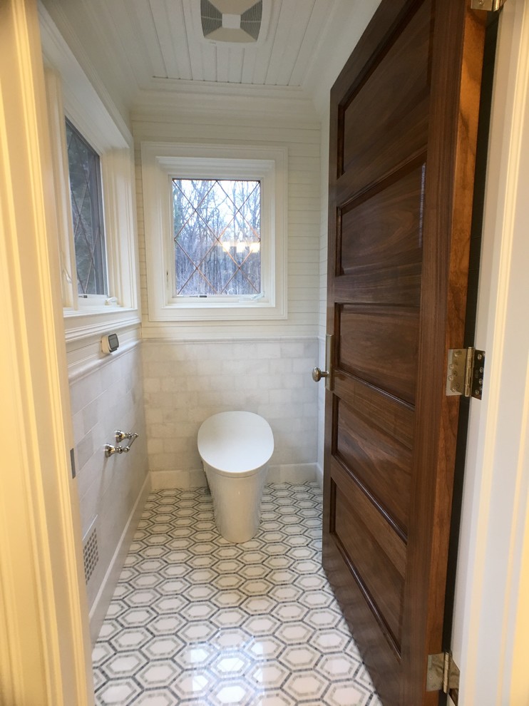 Mid-sized traditional master bathroom in Milwaukee with a one-piece toilet, white walls, mosaic tile floors, flat-panel cabinets, white cabinets, blue tile, stone tile and engineered quartz benchtops.