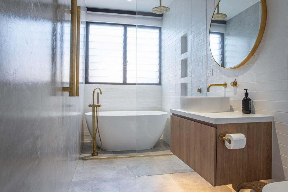 This is an example of a small modern wet room bathroom in Sunshine Coast with furniture-like cabinets, white cabinets, a freestanding tub, white tile, ceramic tile, porcelain floors, engineered quartz benchtops, an open shower, white benchtops, a single vanity and a built-in vanity.