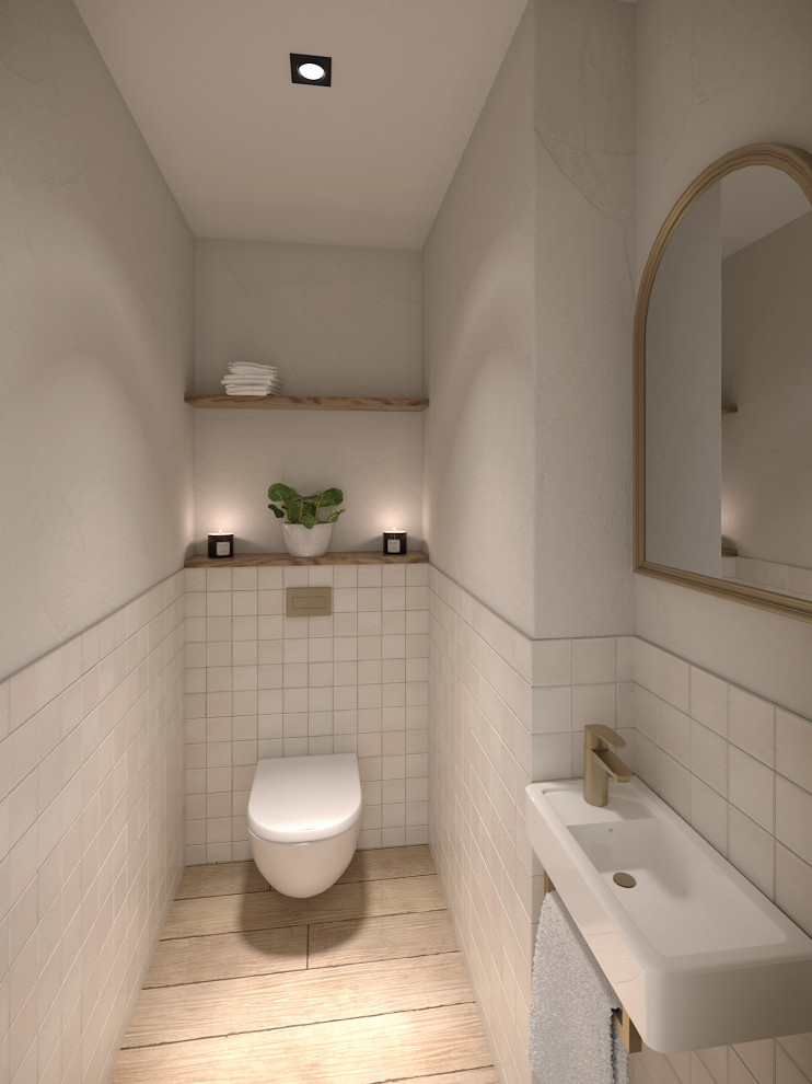 Small mediterranean powder room in Nice with a wall-mount toilet, white tile, ceramic tile, white walls, light hardwood floors, a wall-mount sink and beige floor.