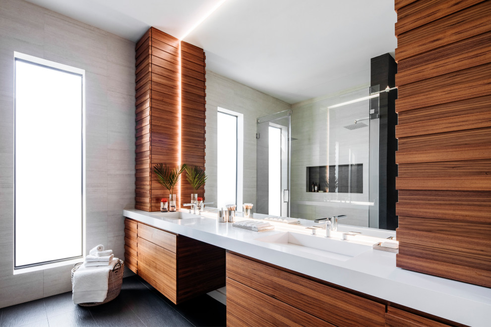 Contemporary master bathroom in Miami with flat-panel cabinets, medium wood cabinets, an alcove shower, an integrated sink, black floor, a hinged shower door and white benchtops.