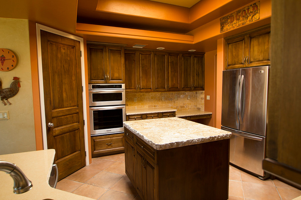 Inspiration for a craftsman u-shaped terra-cotta tile eat-in kitchen remodel in Phoenix with recessed-panel cabinets, dark wood cabinets, beige backsplash, ceramic backsplash, stainless steel appliances and an island