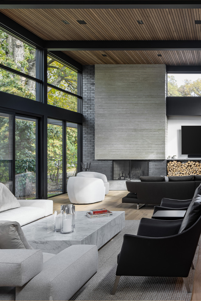 Design ideas for an expansive modern formal loft-style living room in Los Angeles with grey walls, laminate floors, a corner fireplace, a brick fireplace surround, a built-in media wall, beige floor, exposed beam and brick walls.
