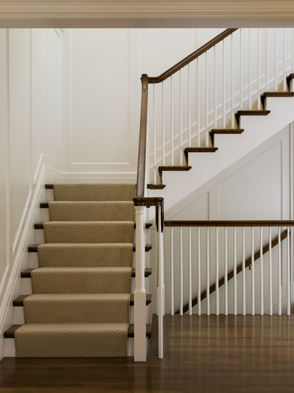 This is an example of a large traditional carpeted curved staircase in San Francisco with wood risers.