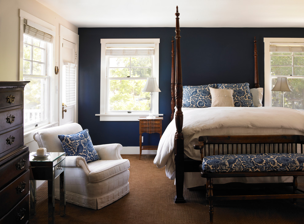 This is an example of a large arts and crafts master bedroom in Los Angeles with blue walls and no fireplace.