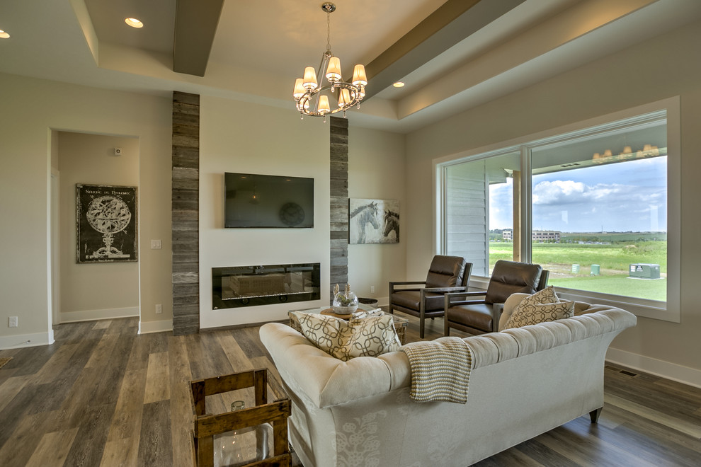 Transitional open concept living room in Omaha with a ribbon fireplace, a wood fireplace surround and a wall-mounted tv.