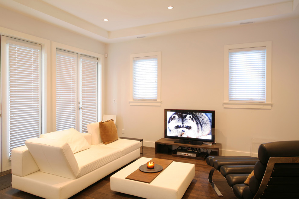 This is an example of a contemporary family room in Vancouver with white walls.