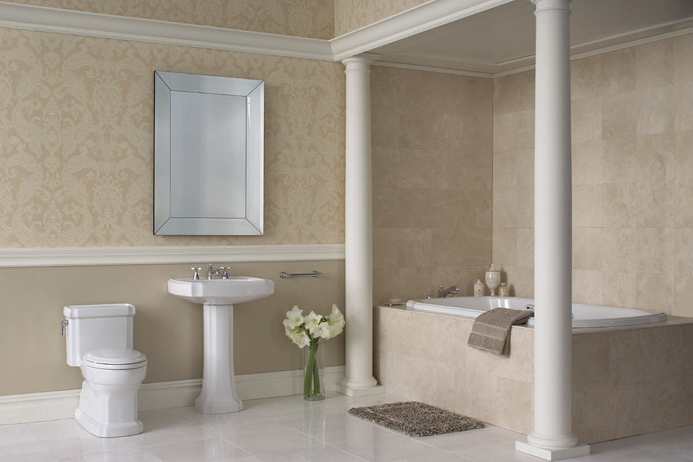 Photo of a large traditional master bathroom in Dallas with a drop-in tub, a one-piece toilet, a pedestal sink, beige walls, beige tile, solid surface benchtops, travertine, marble floors and beige floor.