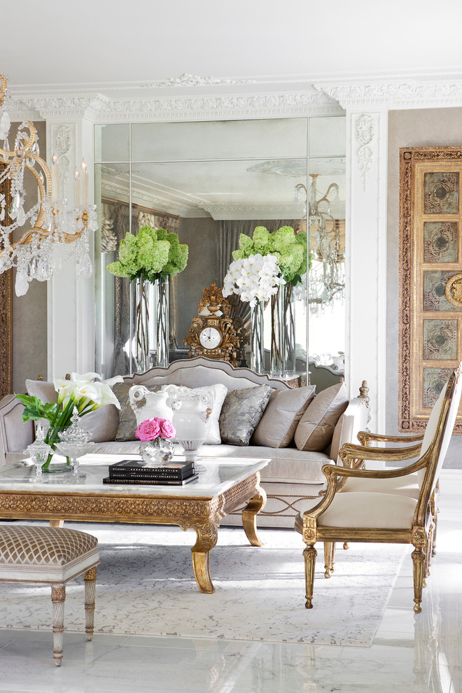 Large traditional formal enclosed living room in Paris with marble floors.