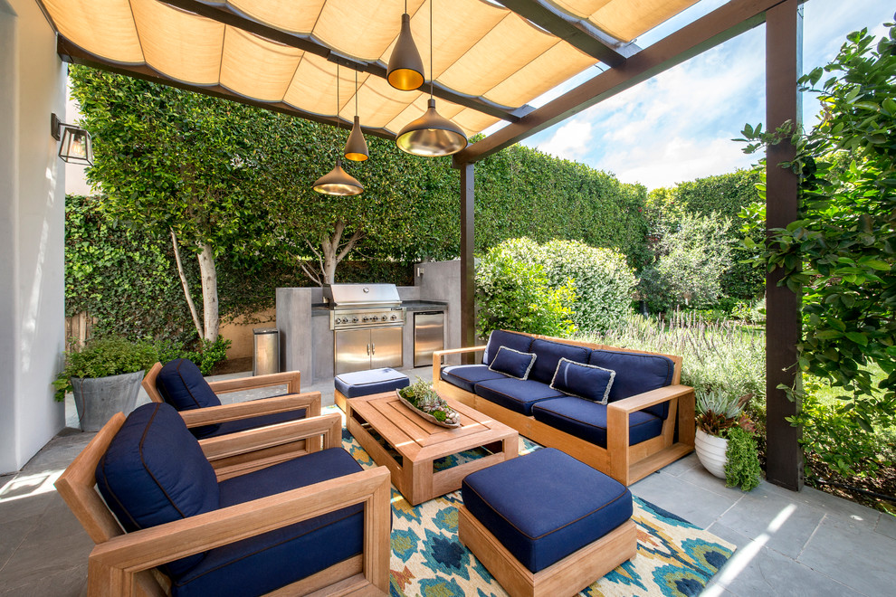 Photo of a transitional patio in Los Angeles with an awning.