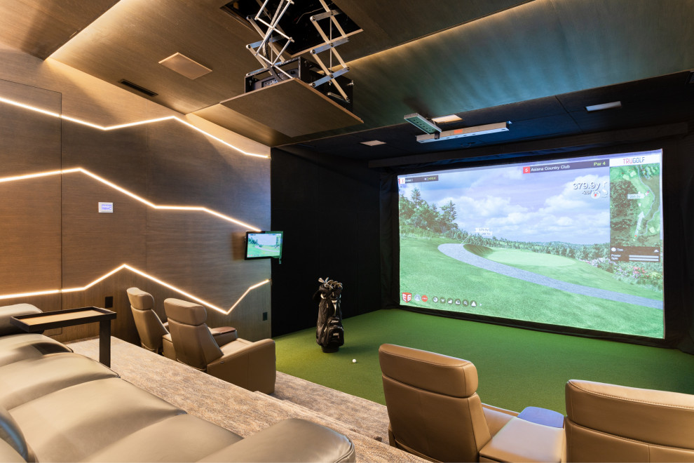 Example of a huge open concept carpeted and green floor home theater design in Salt Lake City with brown walls and a projector screen