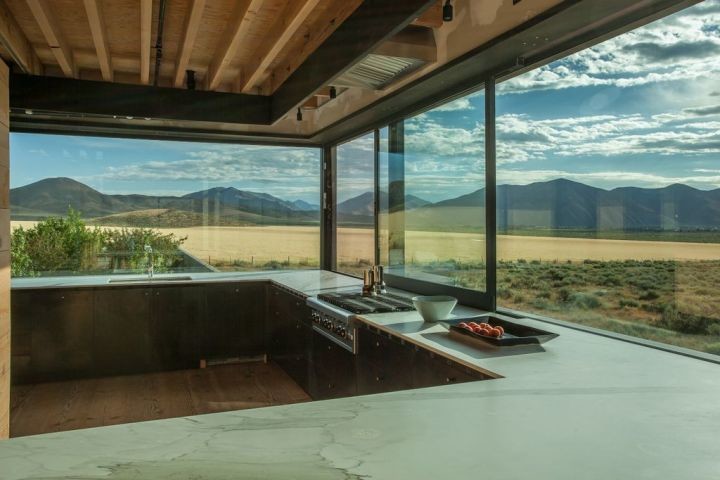 Example of a mountain style u-shaped enclosed kitchen design in Boise with an undermount sink, flat-panel cabinets and dark wood cabinets