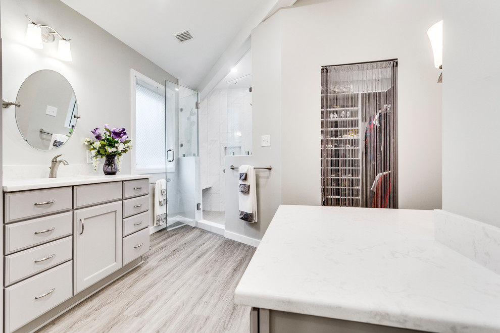 Mid-sized transitional master bathroom in DC Metro with recessed-panel cabinets, grey cabinets, an alcove tub, a corner shower, grey walls, vinyl floors, an undermount sink, engineered quartz benchtops, a hinged shower door and white benchtops.
