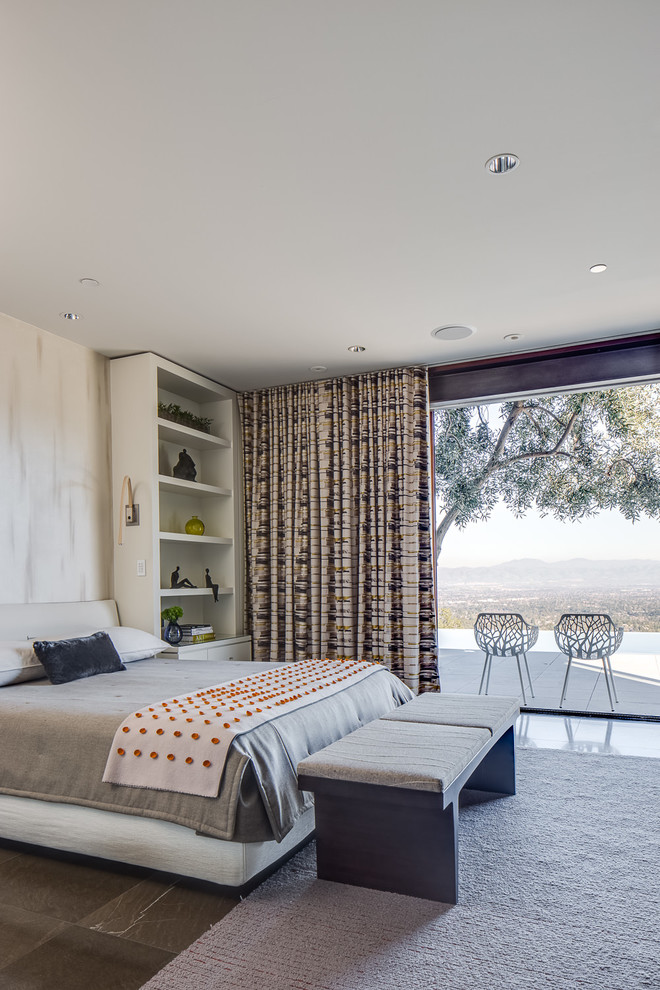 Inspiration for a large modern master bedroom in San Francisco with white walls, brown floor, a standard fireplace and a concrete fireplace surround.