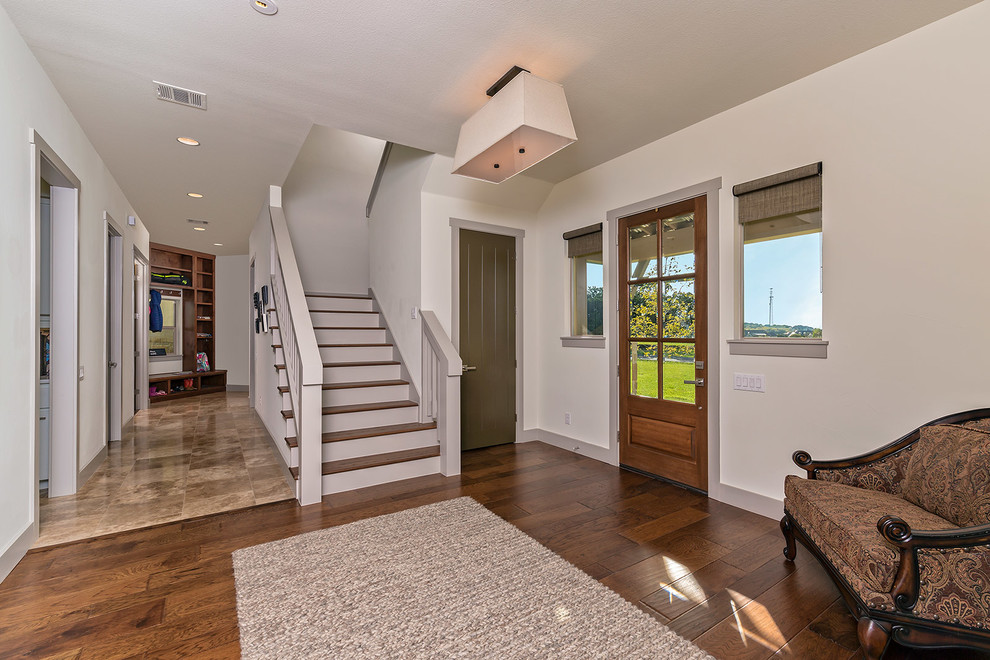 Front door - mid-sized transitional dark wood floor front door idea in Austin with white walls and a medium wood front door