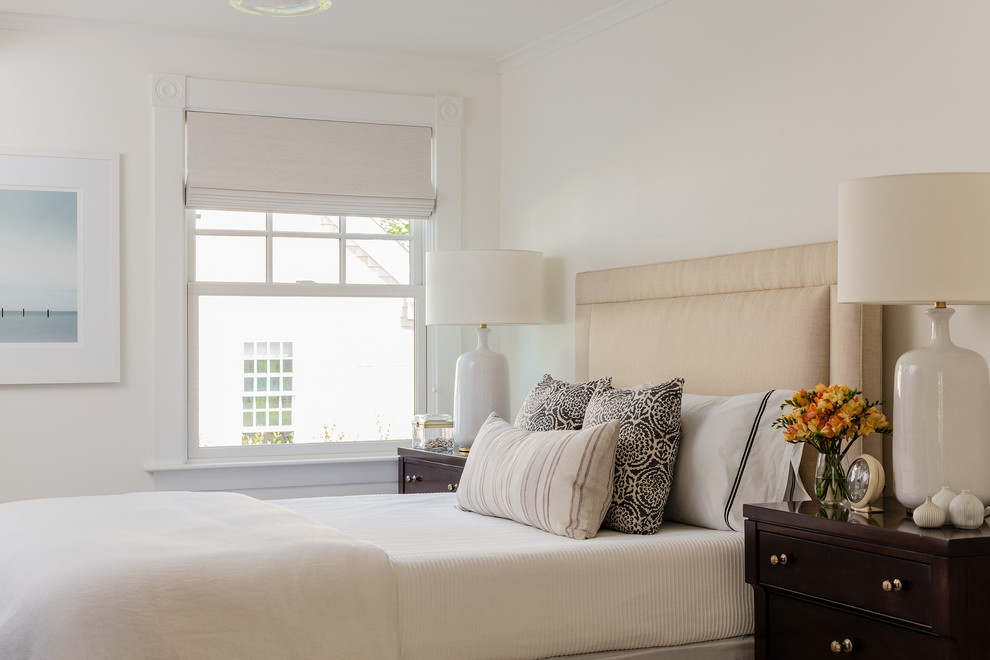 Photo of a beach style master bedroom in Boston with white walls.