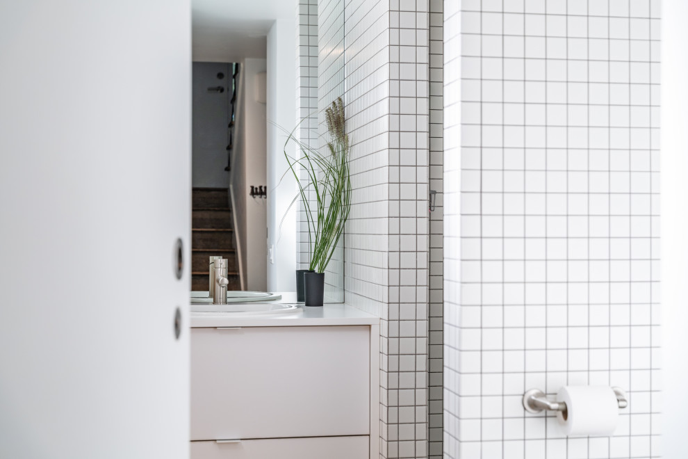 Design ideas for a small industrial bathroom in Vancouver with flat-panel cabinets, white cabinets, a corner shower, a one-piece toilet, white tile, porcelain tile, white walls, concrete floors, a drop-in sink, laminate benchtops, an open shower, white benchtops, a single vanity and a built-in vanity.