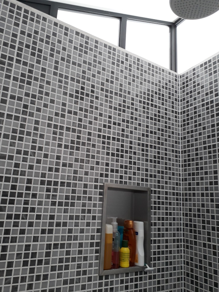 Aménagement d'une petite salle de bain contemporaine avec un carrelage gris, mosaïque, un mur blanc, un sol gris et une cabine de douche à porte coulissante.