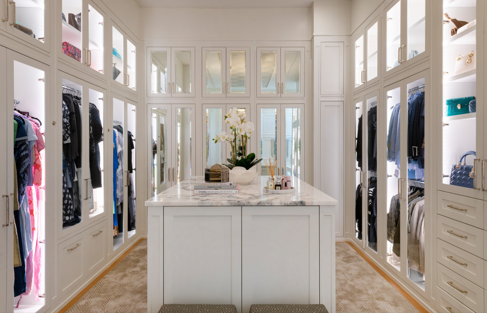 Photo of a large transitional gender-neutral walk-in wardrobe in Dallas with shaker cabinets, white cabinets, carpet, beige floor and wallpaper.