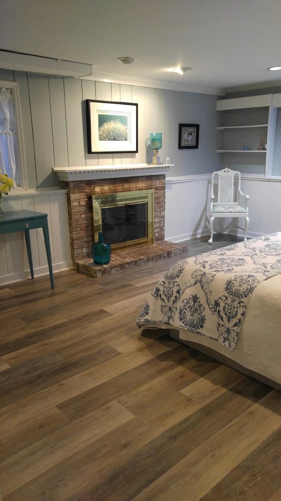 Inspiration for a mid-sized traditional master bedroom in New York with grey walls, medium hardwood floors, a standard fireplace and a brick fireplace surround.
