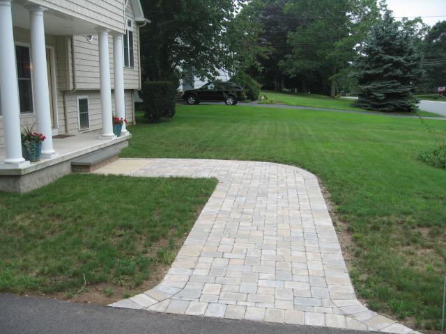 Photo of a mid-sized traditional front yard partial sun garden in Providence with a garden path and brick pavers.