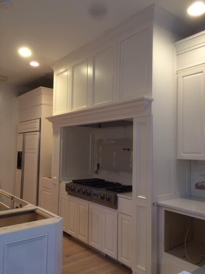 Example of a large transitional u-shaped medium tone wood floor open concept kitchen design in DC Metro with an undermount sink, raised-panel cabinets, white cabinets, quartzite countertops, stainless steel appliances and an island