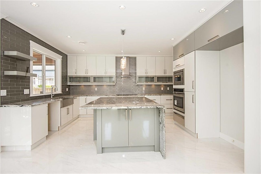 This is an example of a mid-sized contemporary u-shaped separate kitchen in Vancouver with a double-bowl sink, flat-panel cabinets, white cabinets, grey splashback, ceramic splashback, stainless steel appliances, porcelain floors, with island and granite benchtops.