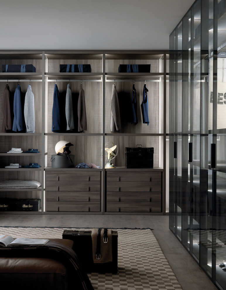 Design ideas for a large contemporary gender-neutral walk-in wardrobe in Dorset with open cabinets, dark wood cabinets and concrete floors.