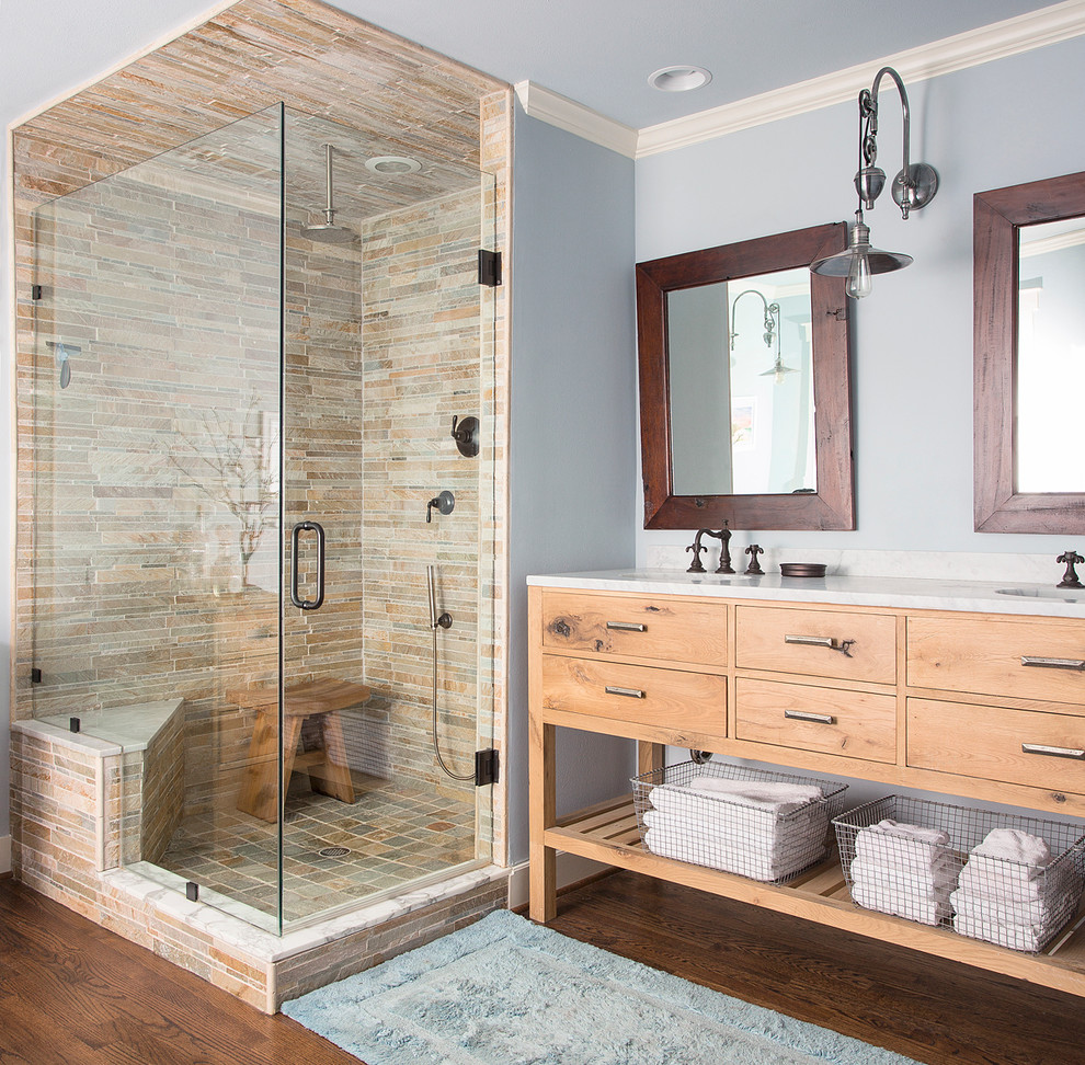Design ideas for a country bathroom in Dallas with flat-panel cabinets, medium wood cabinets, a corner shower, beige tile, blue walls, dark hardwood floors, a claw-foot tub and a shower seat.