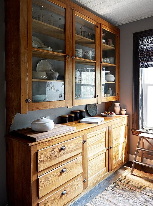 Example of a mid-sized mountain style single-wall painted wood floor enclosed kitchen design in New York with a farmhouse sink, recessed-panel cabinets, gray cabinets, marble countertops, gray backsplash, stainless steel appliances and no island