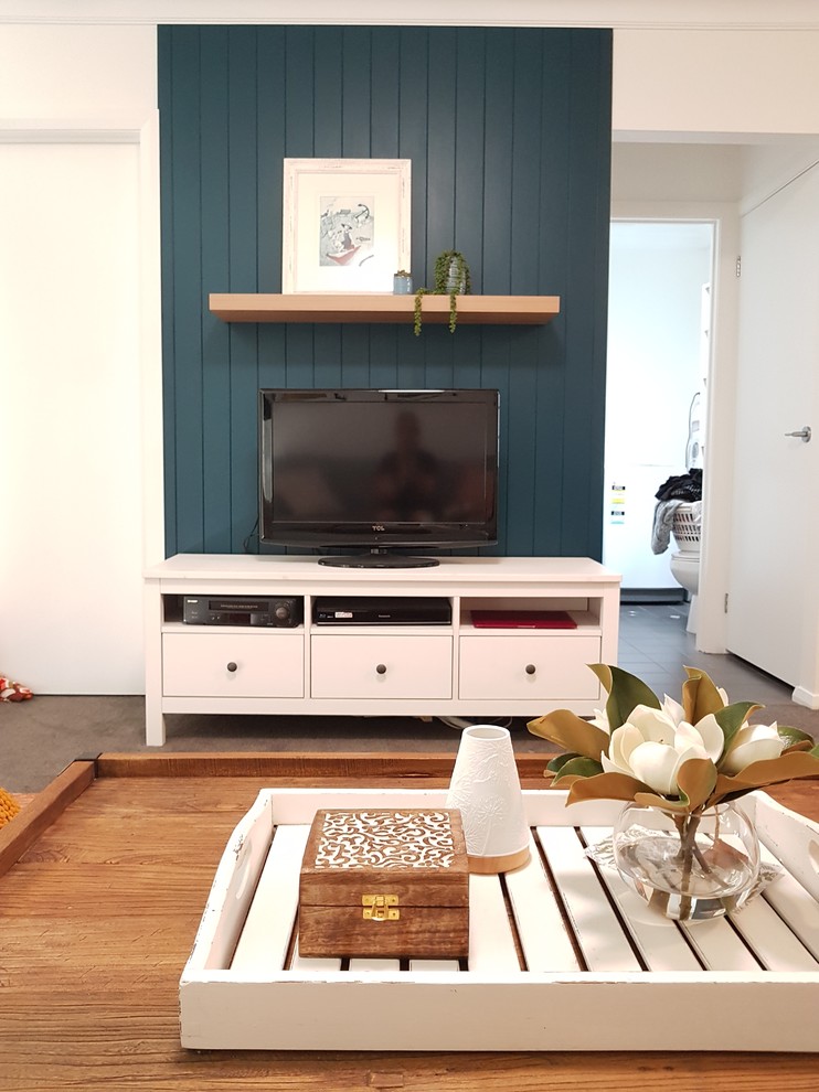 Design ideas for a midcentury living room in Newcastle - Maitland with blue walls and a freestanding tv.