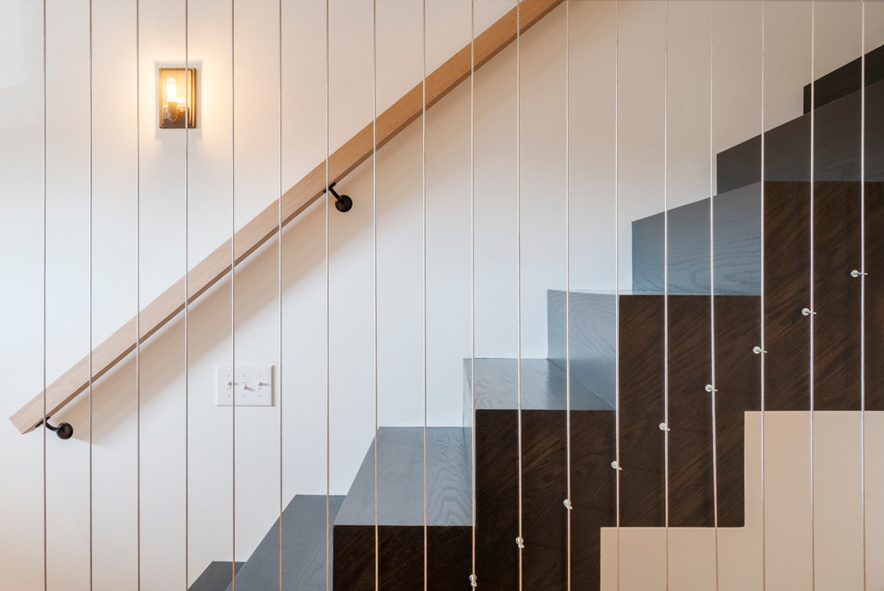 Inspiration for a mid-sized industrial wood straight staircase in Cleveland with wood risers.