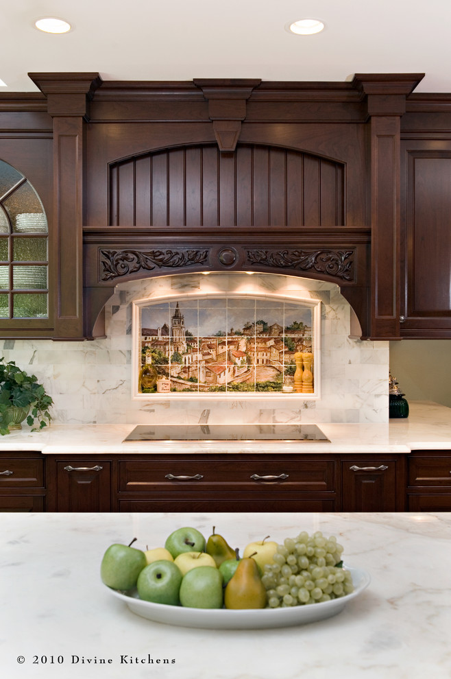 Inspiration for a large traditional l-shaped eat-in kitchen in Boston with a farmhouse sink, raised-panel cabinets, dark wood cabinets, marble benchtops, white splashback, stone tile splashback, stainless steel appliances, dark hardwood floors and with island.