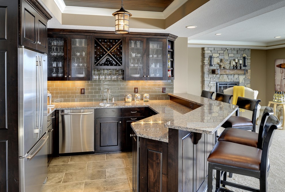 Design ideas for a large traditional u-shaped seated home bar in Minneapolis with shaker cabinets, dark wood cabinets, beige splashback and subway tile splashback.