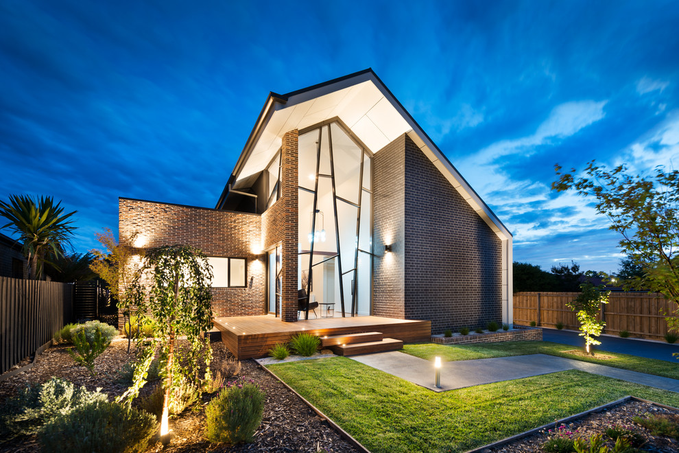 This is an example of a mid-sized contemporary two-storey brick black exterior in Melbourne with a gable roof.