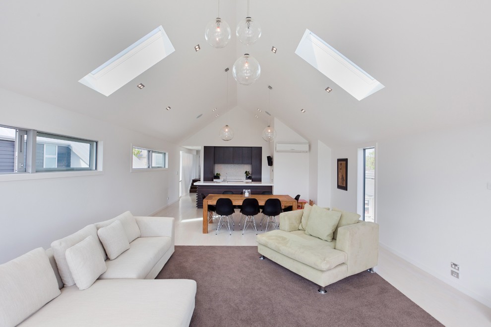 Photo of a mid-sized contemporary open concept living room in Auckland with white walls and light hardwood floors.
