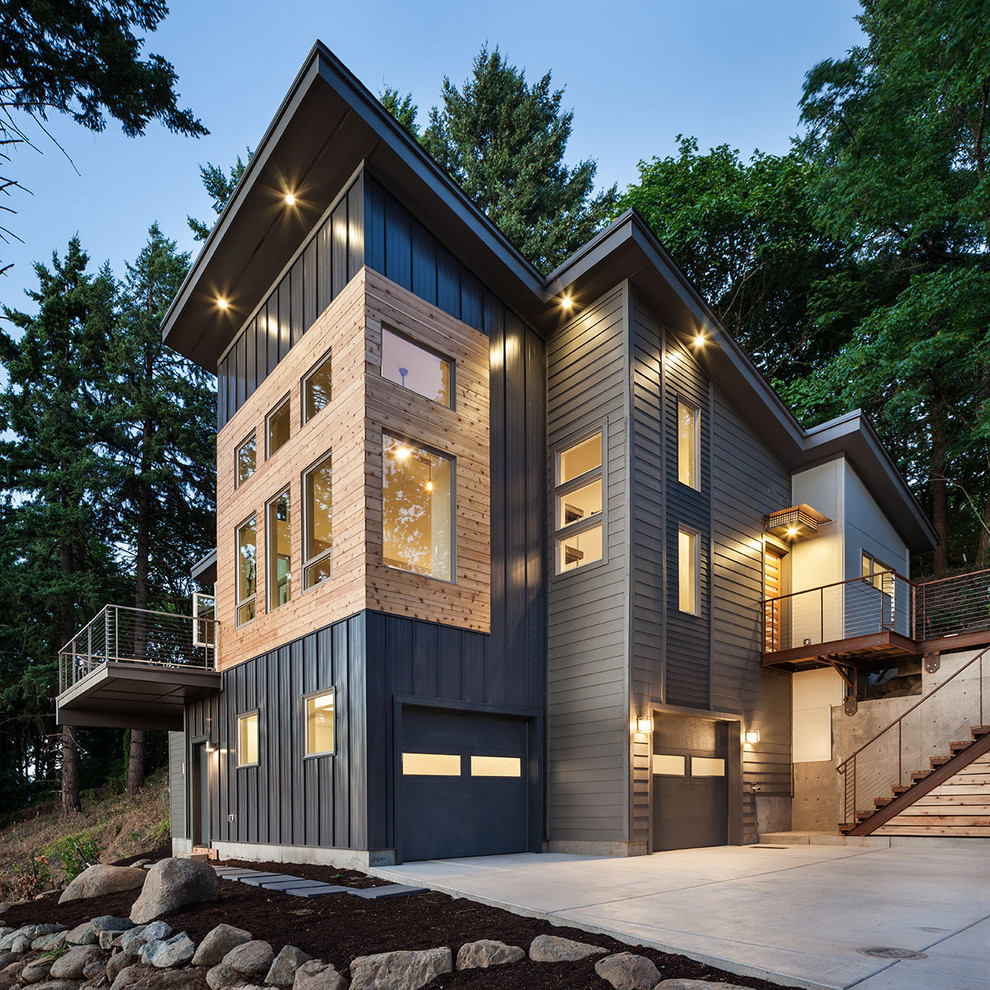This is an example of a large contemporary three-storey grey exterior in Portland with metal siding and a shed roof.