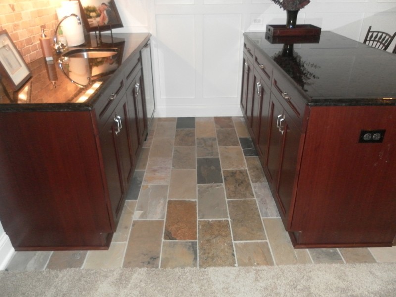 Inspiration for a transitional kitchen remodel in Chicago with an undermount sink, dark wood cabinets, granite countertops, stone tile backsplash and stainless steel appliances