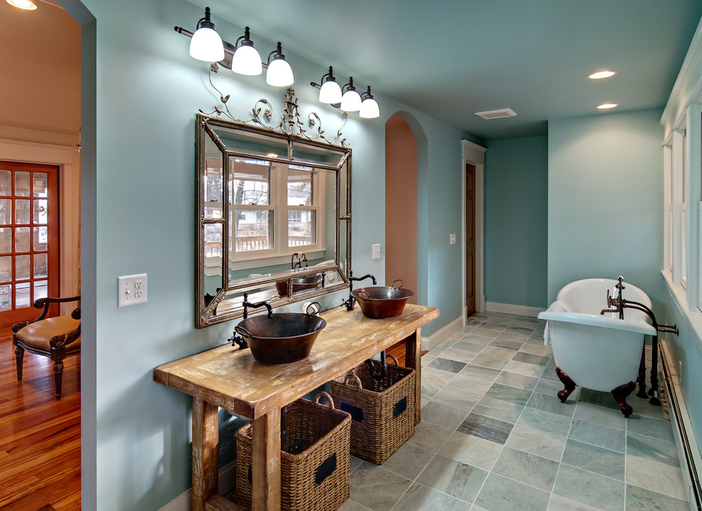 Traditional bathroom in Minneapolis with a freestanding tub and a vessel sink.