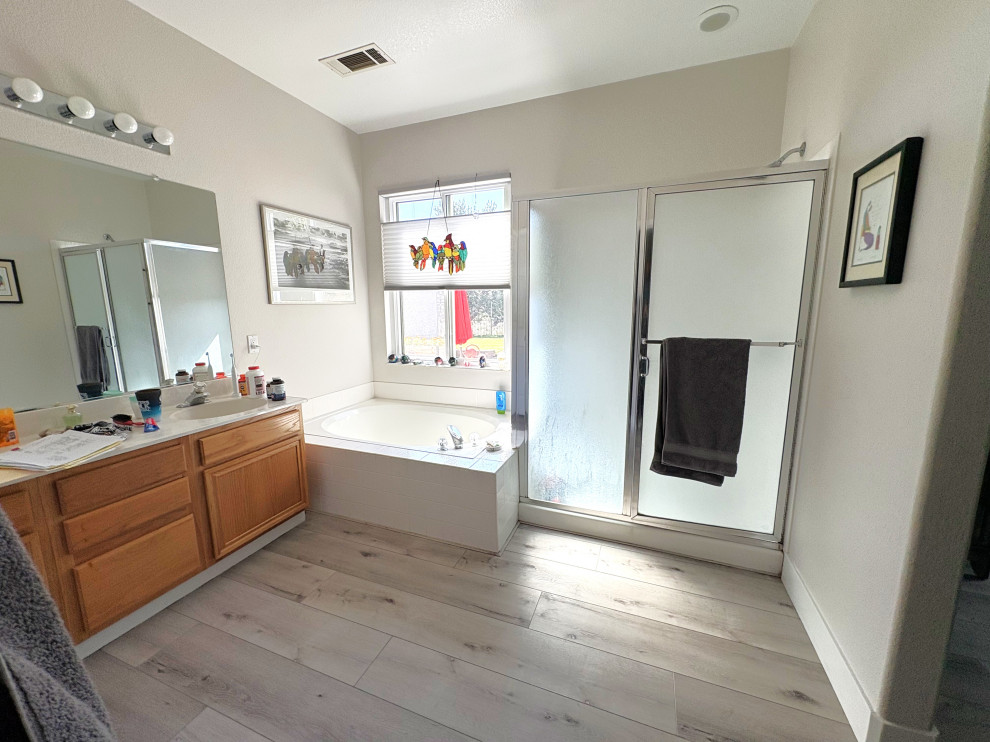Alcove shower - large transitional master beige tile and porcelain tile vinyl floor, brown floor and double-sink alcove shower idea with shaker cabinets, white cabinets, beige walls, an undermount sink, quartzite countertops, white countertops and a built-in vanity