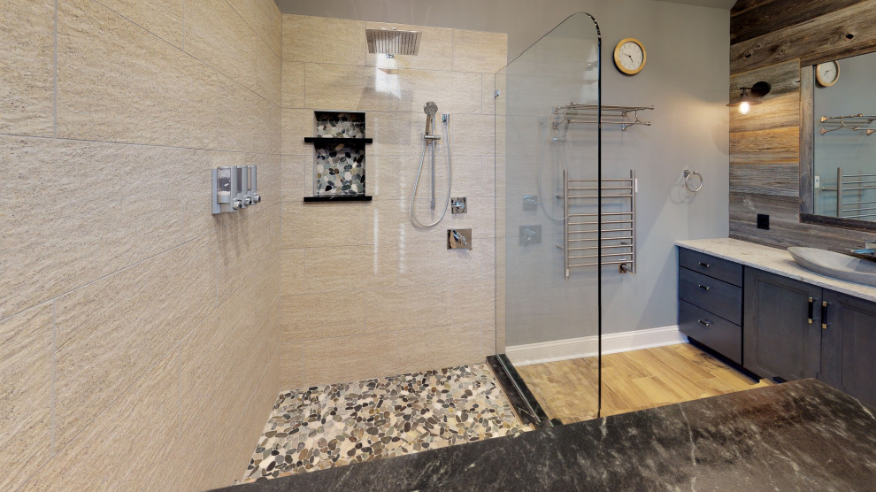 Photo of a large traditional ensuite bathroom in Philadelphia with recessed-panel cabinets, dark wood cabinets, a freestanding bath, a corner shower, a two-piece toilet, beige tiles, blue walls, laminate floors, a vessel sink, brown floors, an open shower, beige worktops, double sinks, a built in vanity unit, a vaulted ceiling and wood walls.