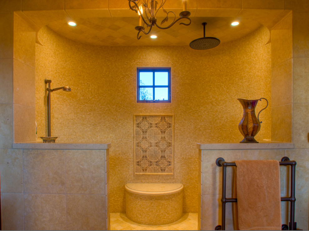 Design ideas for a large mediterranean master bathroom in Other with shaker cabinets, light wood cabinets, limestone benchtops, limestone floors, a vessel sink and beige tile.