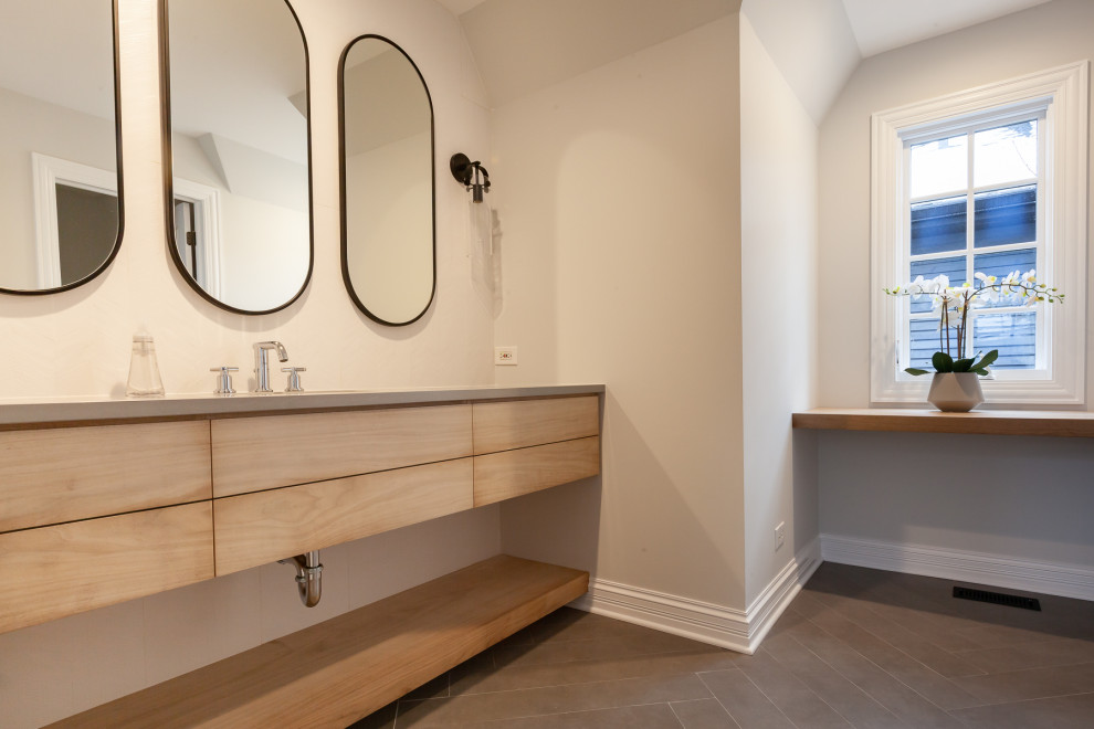 Design ideas for a large transitional powder room in Chicago with flat-panel cabinets, light wood cabinets, white tile, porcelain tile, an undermount sink, engineered quartz benchtops, grey floor, grey benchtops and a floating vanity.
